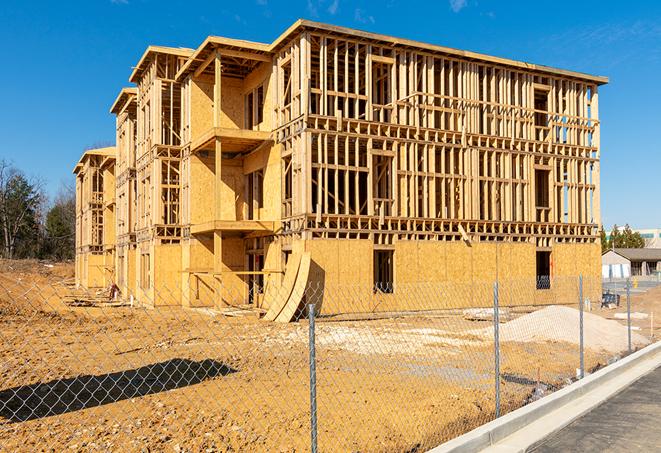 a close-up of temporary chain link fences enclosing a construction site, signaling progress in the project's development in Hidden Hills, CA